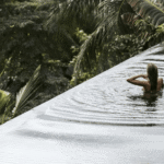 Person in serene infinity pool at One Beverly Hills