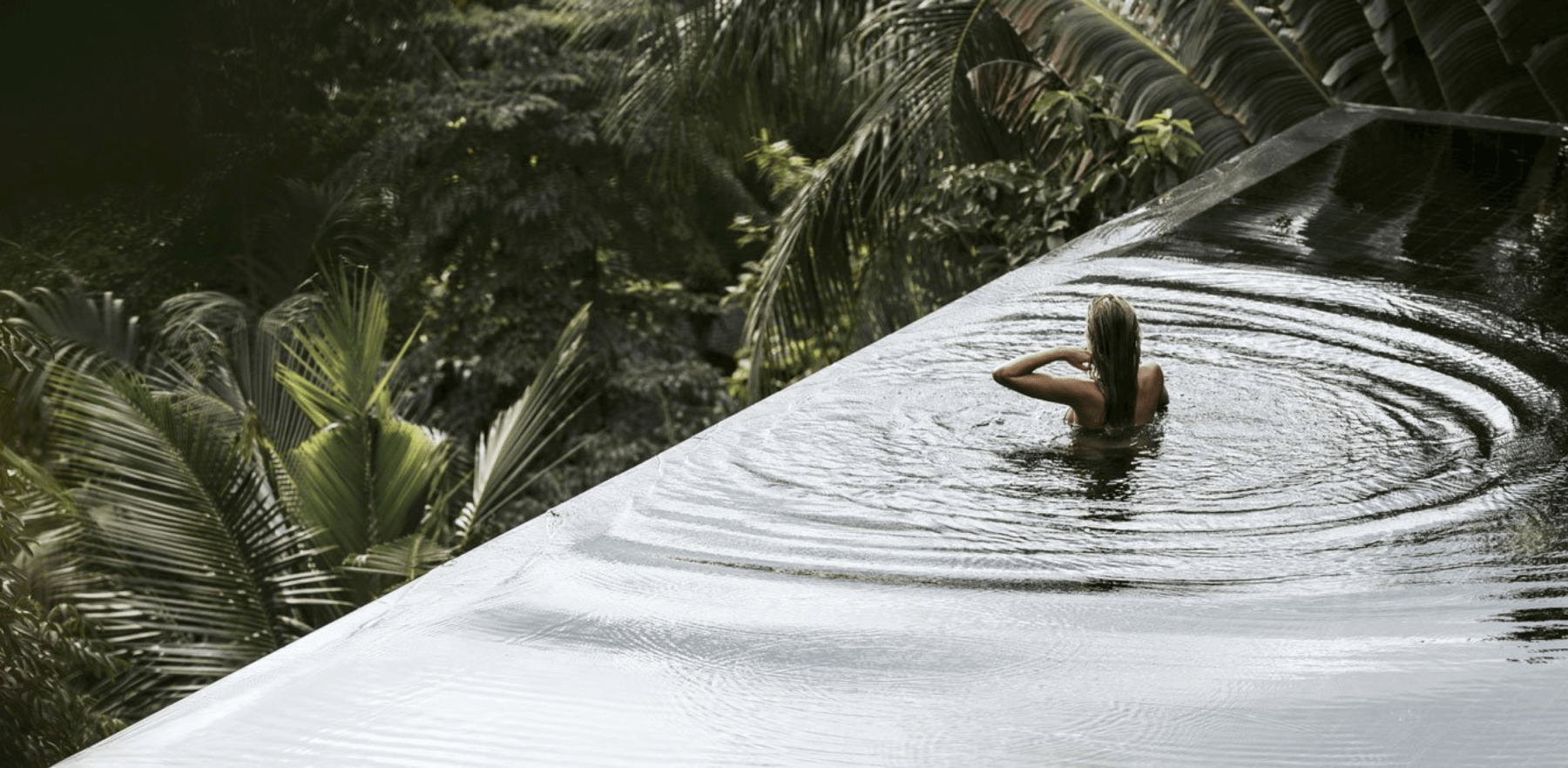 Person in serene infinity pool at One Beverly Hills